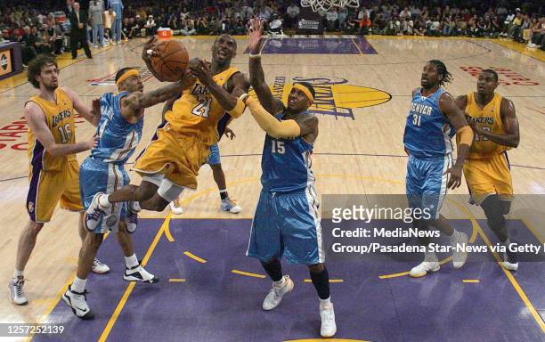 Los Angeles, CA Carmelo Anthony announces his retirement from NBA after 19-year career. Lakers Kobe Bryant drives to the basket past Nuggets Carmelo...