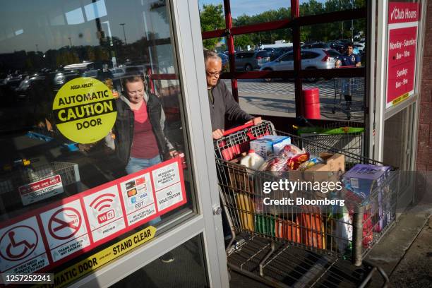 Shoppers exit a BJ's Wholesale Club location in the Queens borough of New York, US, on Friday, May 19, 2023. BJ's Wholesale Club Holdings Inc. Is...