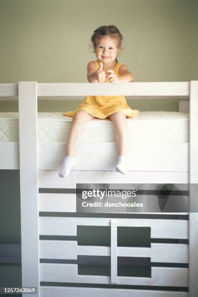 young man with his daughter assembling furniture at home - kids in bunk bed stock pictures, royalty-free photos & images