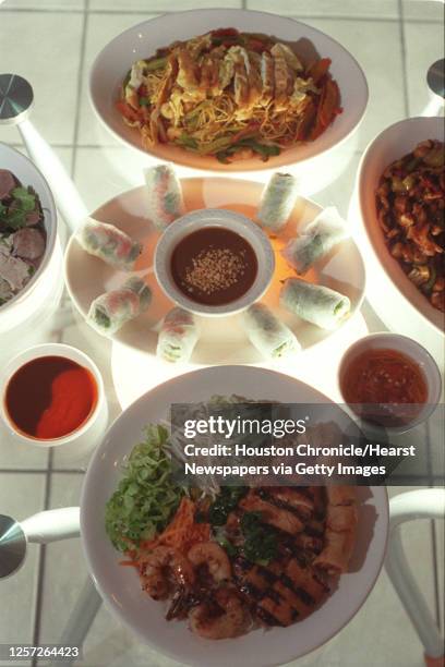 Foreground is Chargrilled Chicken with egg roll...Middle: Spring rolls, chicken and shrimp...Background: Vietnamese Beef Noodle Soup...Left side:...