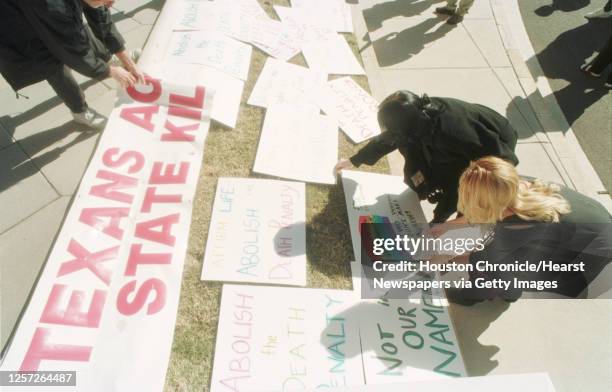 People place protest signs on the lawn in front of the state Capitol in Austin during a rally to abolish Texas' death penalty and plead for the life...