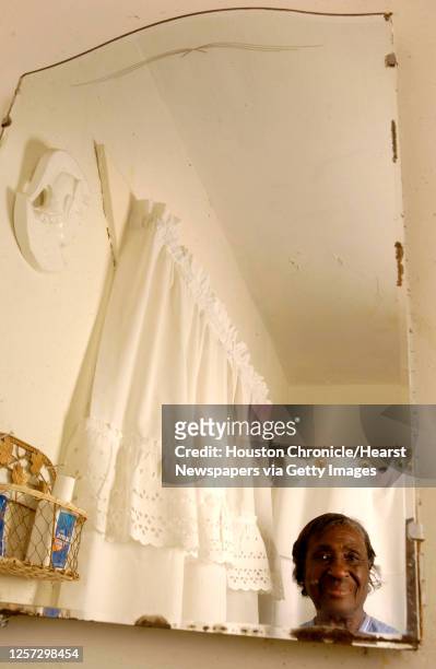 Ella Greer stands in the bathroom of her Houston home, where her ceiling is cracked and peeling and leaks everytime that it rains. Greer has been...