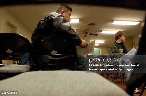 Alain Cisneros,left, talks, during an ACORN meeting with others, including Tim Barr, in the Spring Branch area to discuss problems with landlords who...