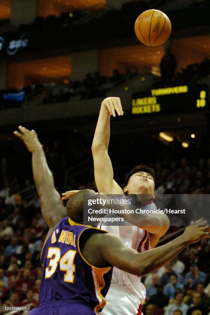 Shaq Rockets Yao Ming tries to get a basket over Laker's Shaquille O'Neal, during ...