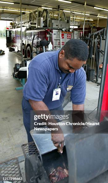 Gerald Cook Firefighter/EMT Gerald Cook checks on the progress of his pork ...