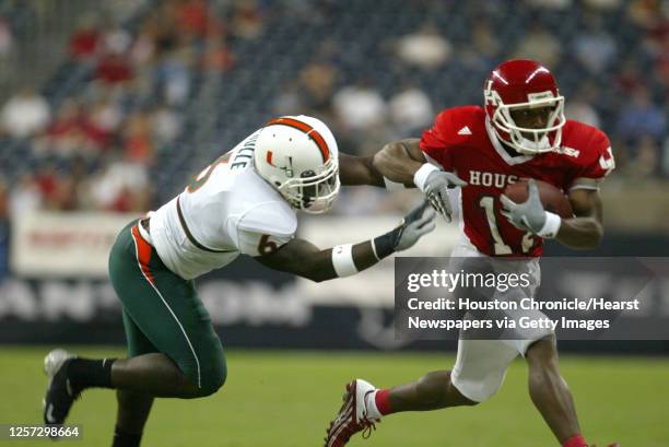 Houston's, Vincent Marshall runs with the ball against Miami's, Antrel Rolle during the first half of the University of Houston-Miami football game...