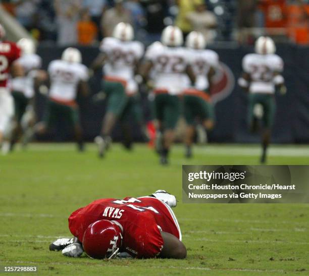 Houston's Roy Swan lies on the turf injured after Miami recovered a fumble for a touchdown during the third quarter of the University of...