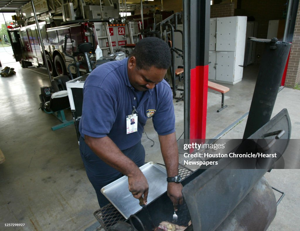 Gerald Cook Firefighter/EMT Gerald Cook checks on the progress of his pork ...