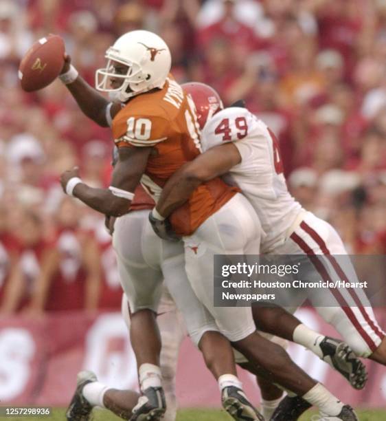 Quarterback Vincent Young is brought down for a sack by OU's, Jonathan Jackson in the 2nd half, during the University of Texas-Oklahoma University...