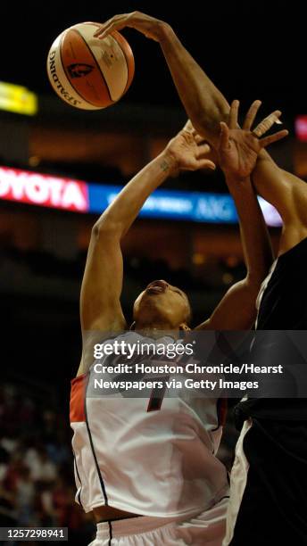 Houston's Tina Thompson goes up for a basket against San Antonio's, Jessie Hicks , during the first half of the season opener WNBA game between the...