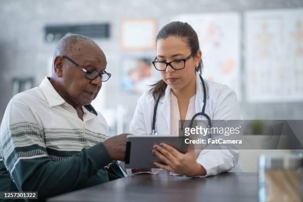 man seeing his medical test results on tablet - diabetes care stock pictures, royalty-free photos & images