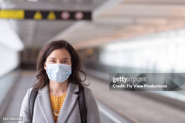 a young solo traveller at an empty airport - airport mask stock pictures, royalty-free photos & images