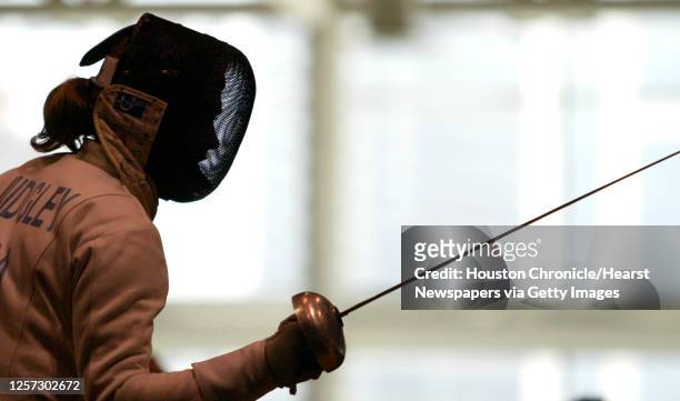 Elizabeth Morgan Midgley, of Columbia University, is silhouetted against the windows during one of her bouts in the Women's Epee event during the...