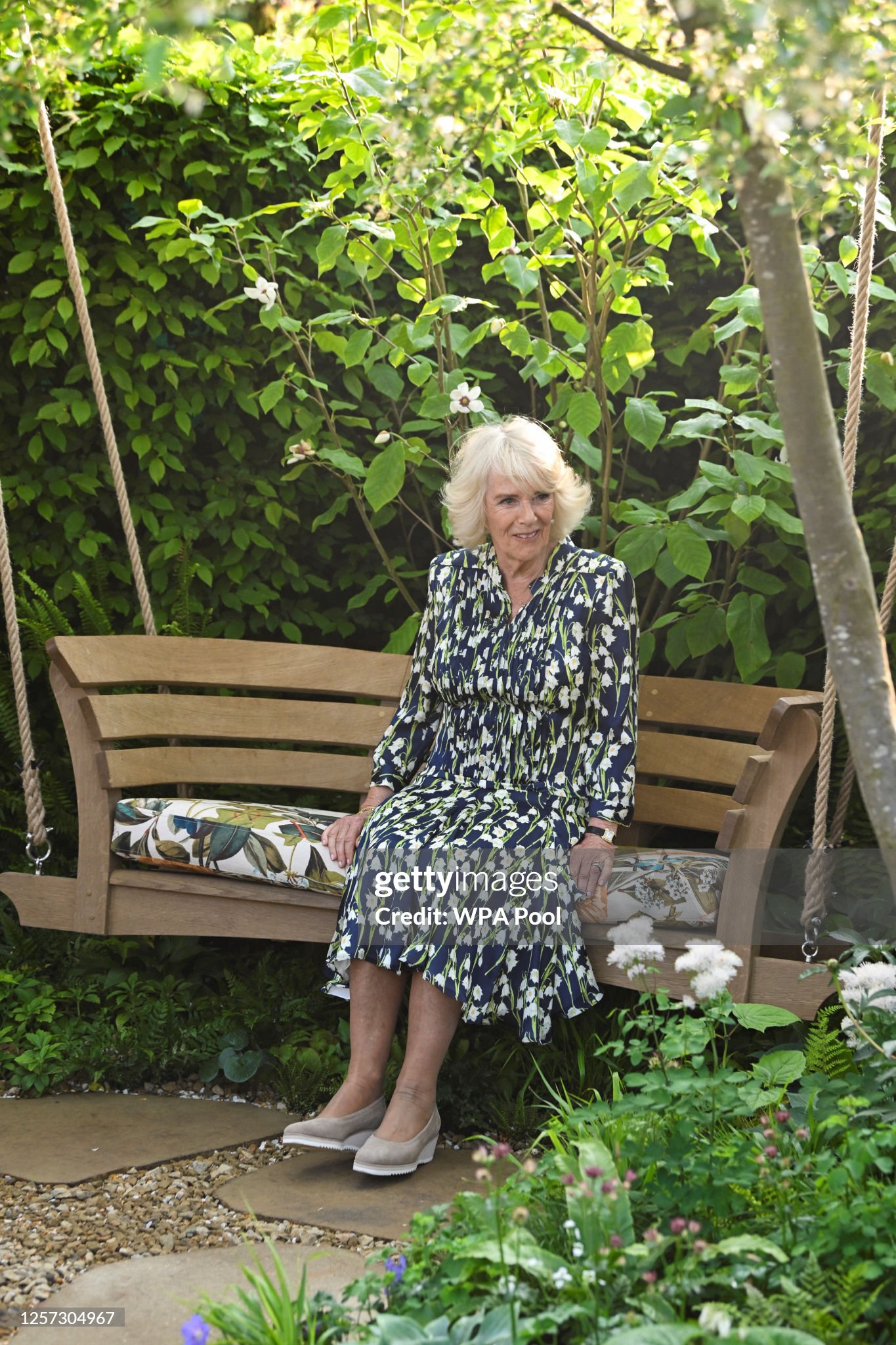 britains-queen-camilla-sits-on-a-swing-bench-in-london-square-community-garden-at-chelsea.jpg