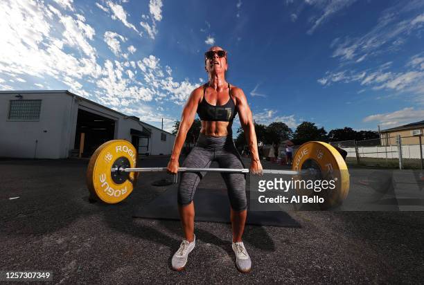 Alex Duki power lifts during an outdoor Jetty Gym "Outside The Box" fitness workout on July 20, 2020 in Oceanside, New York. New York Governor Andrew...