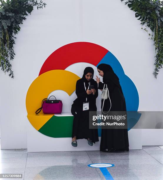 Women standing next to the Google Cloud logo at the launching event of Google Cloud region in Doha at Qatar National Convention Centre in Doha,...