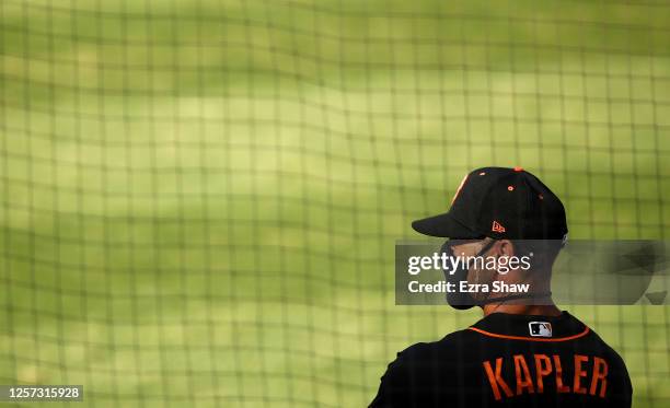 Manager Gabe Kapler of the San Francisco Giants stands in the dugout before their exhibition game against the Oakland Athletics at Oakland-Alameda...