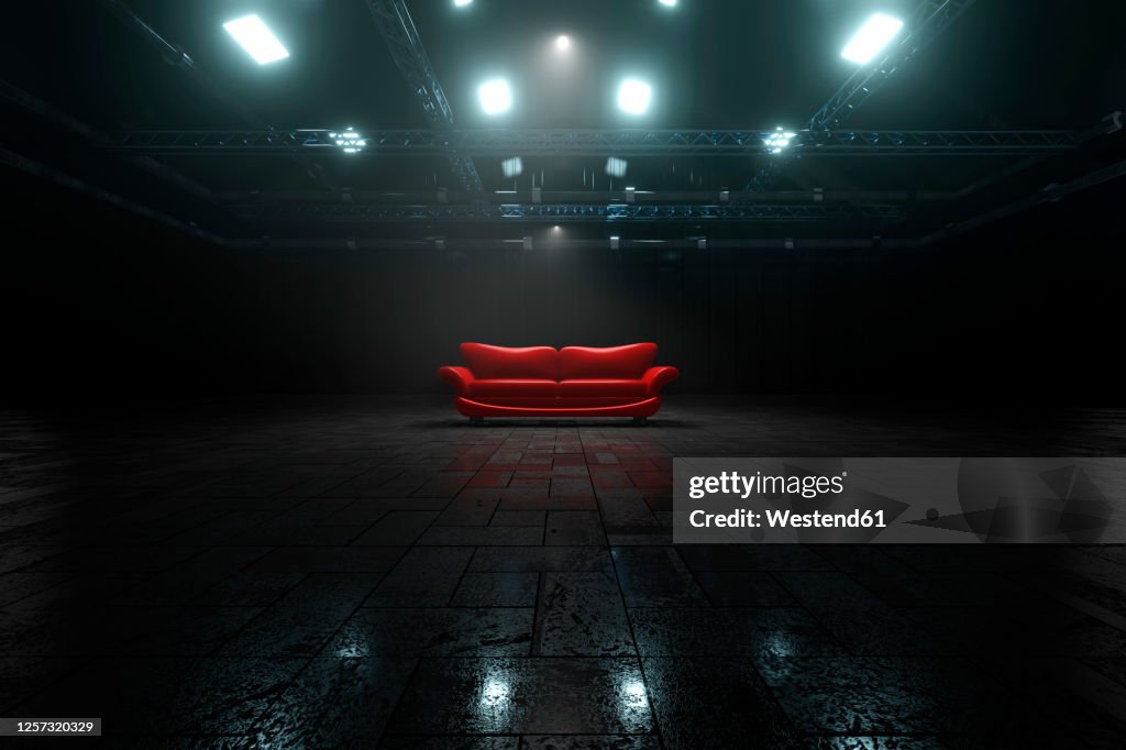 Three dimensional render of red sofa inside dark warehouse