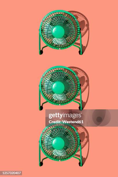 stockillustraties, clipart, cartoons en iconen met green electric fans against orange background - elektrische ventilator