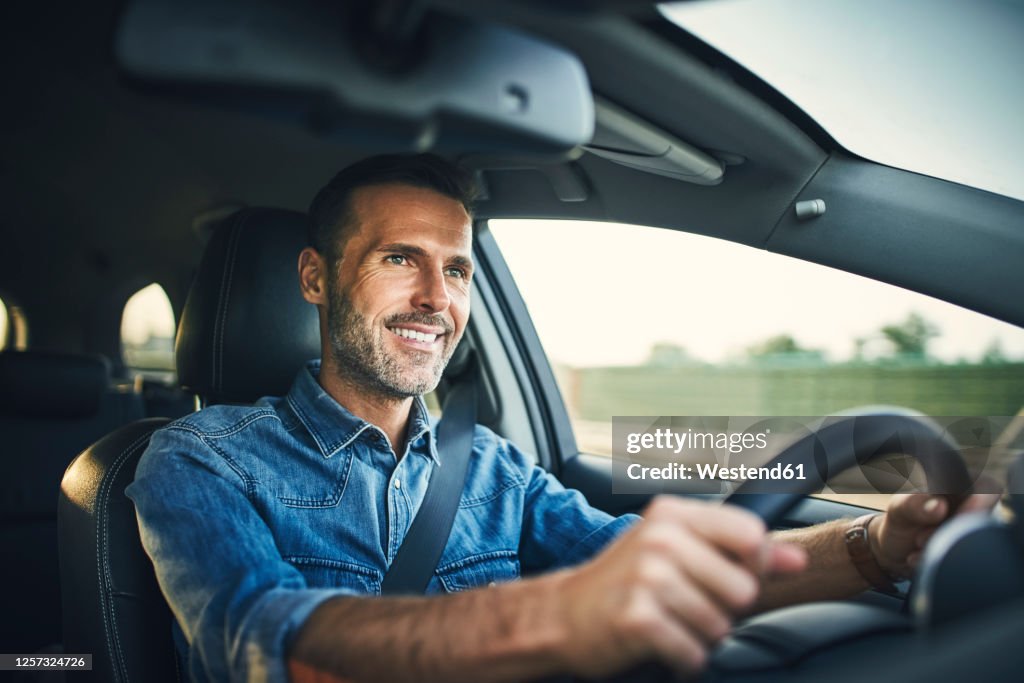 Handsome man driving a car