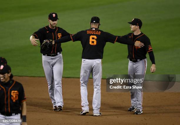 Austin Slater, Steven Duggar and Mike Yastrzemski of the San Francisco Giants celebrate after they beat the Oakland Athletics in their exhibition...