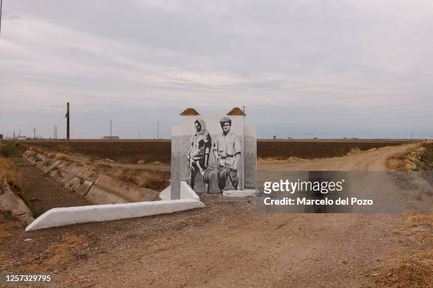 Graffiti artwork piece of rice farmers next to a dry rice field on May 22, 2023 in Isla Mayor, Spain. An estimated 60 per cent of the Spanish...
