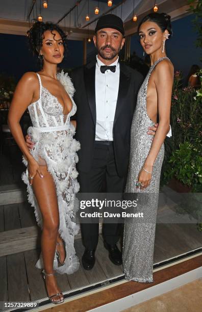 Maya Jama, Riccardo Tisci and Neelam Gill attend a party hosted by British Vogue and Chopard to celebrate the Cannes Film Festival at Hotel Martinez...
