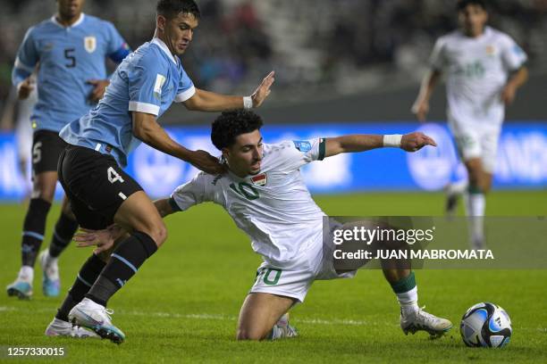 Iraq's midfielder Youssef Amyn vies for the ball with Uruguay's defender Mateo Ponte during the Argentina 2023 U-20 World Cup Group E football match...