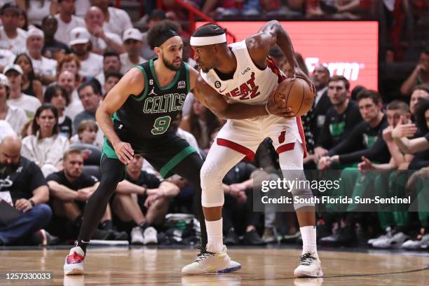 Miami Heat forward Jimmy Butler drives the ball while being defended by Boston Celtics guard Derrick White during the first half of Game 3 of the...