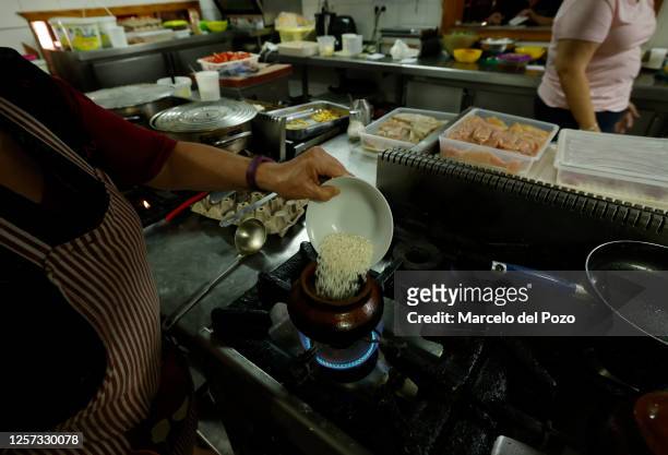 Cook cooks rice in a restaurant kitchen on May 22, 2023 in Isla Mayor, Spain. An estimated 60 per cent of the Spanish countryside has been affected...