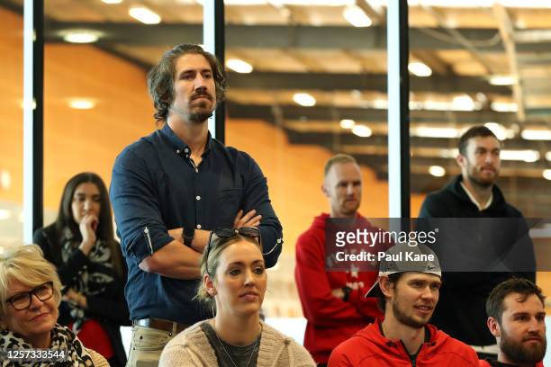 Greg Hire looks on together with players, staff and family members as Damian Martin announces his retirement during a Perth Wildcats NBL media...