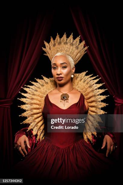 historical mixed race queen character on the throne - queens stock pictures, royalty-free photos & images