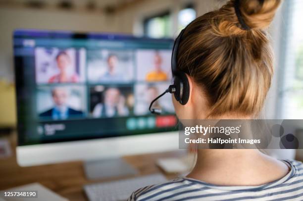 rear view of young student with computer learning at home, homeschooling concept. - distance learning stock pictures, royalty-free photos & images