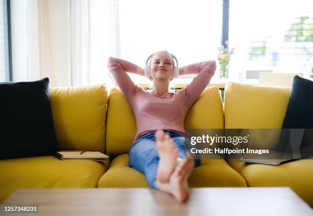 young student with headphones learning and relaxing at home, homeschooling concept. - teen girl barefoot at home stock pictures, royalty-free photos & images