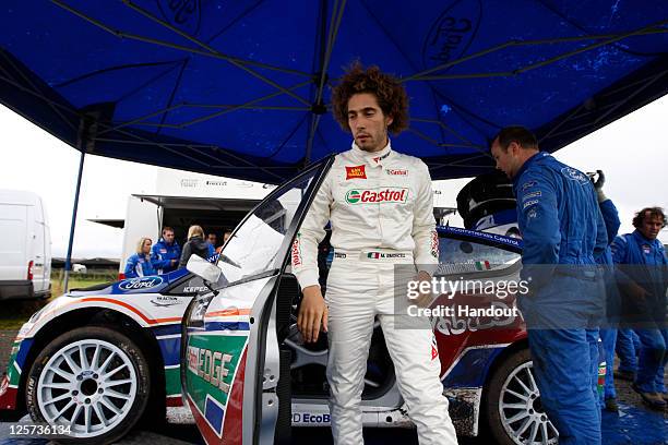 In this handout image supplied by Castrol, Moto GP rider Marco Simoncelli of Italy ptakes part in a one-off test with the Castrol sponsored Ford Abu...