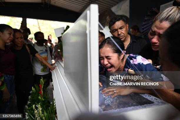 Mandy mourns during the funeral of her mother, Leslie Ferman Murcia a victim of a stampede at the Cuscatlan stadium during a Salvadoran First...