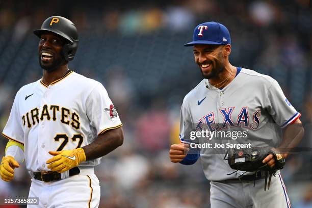 Andrew McCutchen of the Pittsburgh Pirates and Marcus Semien of the Texas Rangers smile during the game between the Texas Rangers and the Pittsburgh...