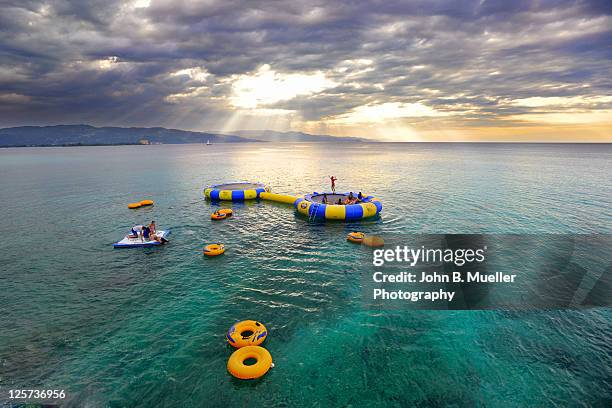 trampolines at sunset - montego bay stock pictures, royalty-free photos & images