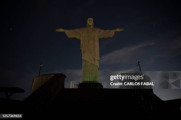 The Christ the Redeemer statue is seen without illumination to condemn racist acts against Brazilian footballer Vinicius Junior in Rio de Janeiro,...