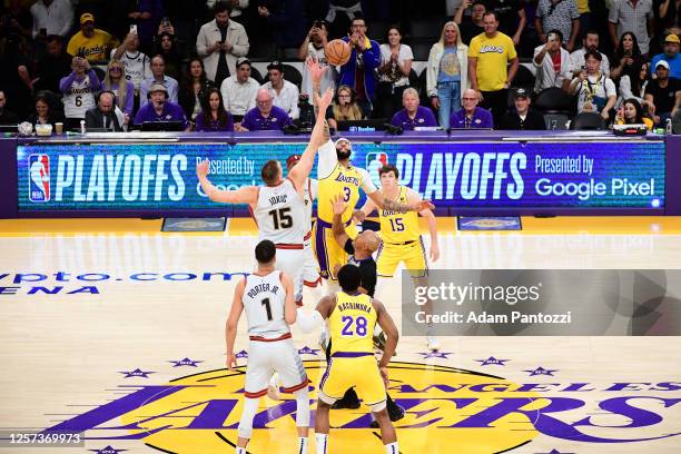 Nikola Jokic of the Denver Nuggets and Anthony Davis of the Los Angeles Lakers go up for the opening tip off during Game 4 of the 2023 NBA Playoffs...