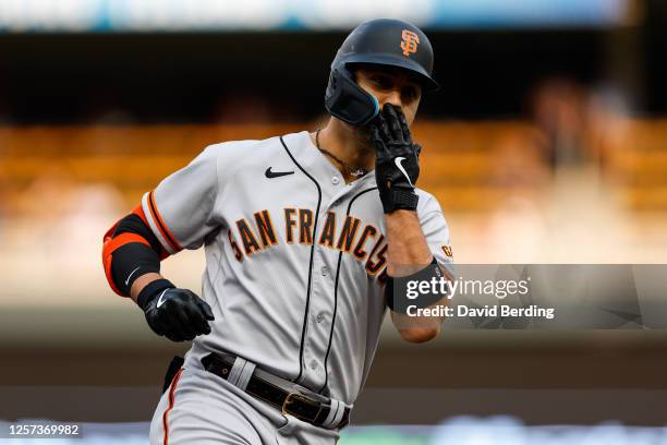 Michael Conforto of the San Francisco Giants celebrates his three-run home run as he rounds the bases against the Minnesota Twins in the first inning...