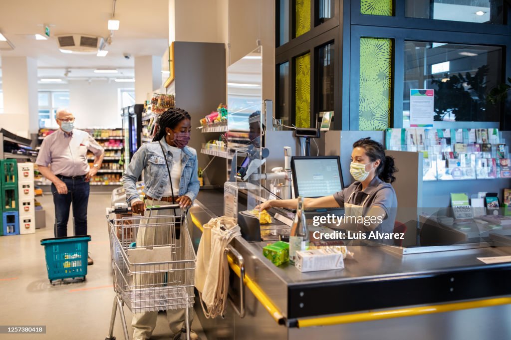 African woman buying groceries at supermarket