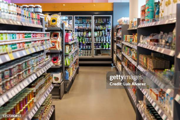 supermarket aisles with variety of products - supermarktgang stock-fotos und bilder