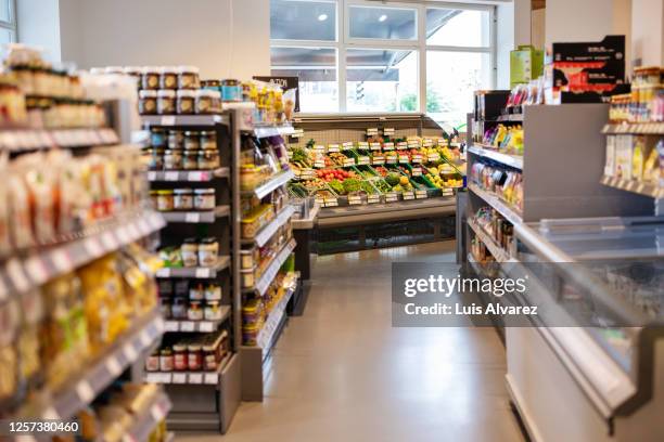 grocery store with variety of products on shelves - supermarket fruit stockfoto's en -beelden