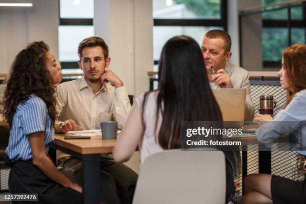 multicultural teams bring rich and varied points of view - round table discussion stock pictures, royalty-free photos & images