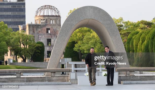 Ukrainian President Volodymyr Zelenskyy and Japanese Prime Minister Fumio Kishida are pictured after offering flowers at the cenotaph for atomic bomb...