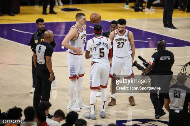 Denver Nuggets center Nikola Jokic , guard Kentavious Caldwell-Pope , and guard Jamal Murray check the game ball during game 4 of the NBA Western...