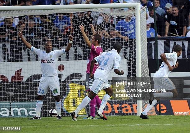 Marseille's french forward Loic Remy celebrates eyed by his teammate, Ghana's Andre Ayew after scoring a goal during the French L1 football match...