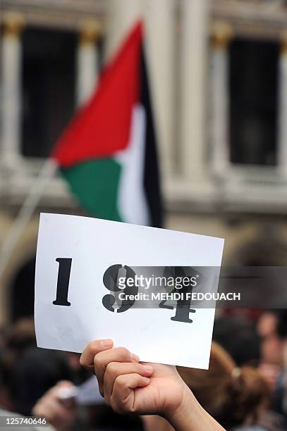 Woman holds a placard reading "194" during a demonstration on the square in front of the Opera on September 21, 2011 in Paris, to support Palestinian...