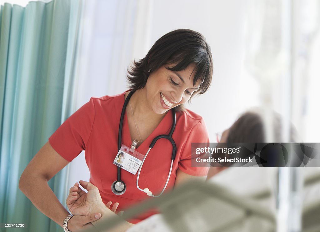 Nurse checking on male patient 